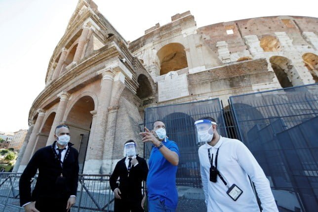 Workers of Rome's ancient Colosseum wear protective visors as it is being reopened with social distancing and hygiene measures in place, after months of closure due to the spread of the coronavirus disease (COVID-19), in Rome, Italy June 1, 2020. REUTERS/Yara Nardi