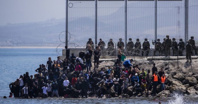 Spain vows to restore order after thousands swim into Ceuta from Morocco