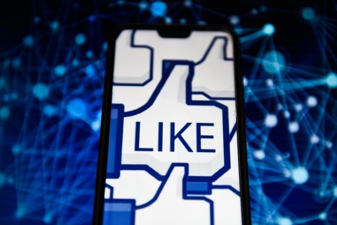 Facebook like logo is seen on an android mobile phone