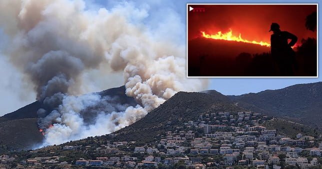 Smoke billowing from a fire raging near El Port de la Selva and Llanca close to the Cap de Creus Natural Park on July 16, 2021.