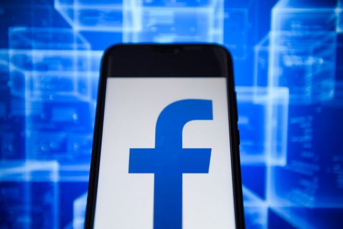 Facebook logo is seen on an android mobile phone