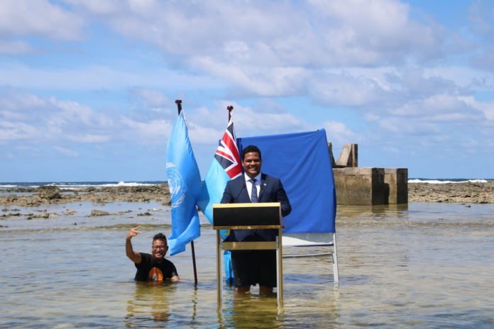 Tuvalu minister gives COP26 speech knee-deep in the ocean to highlight rising sea levels