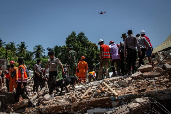 Rescue workers look for survivors of Sunday's earthquake on the Indonesian island of Lombok.