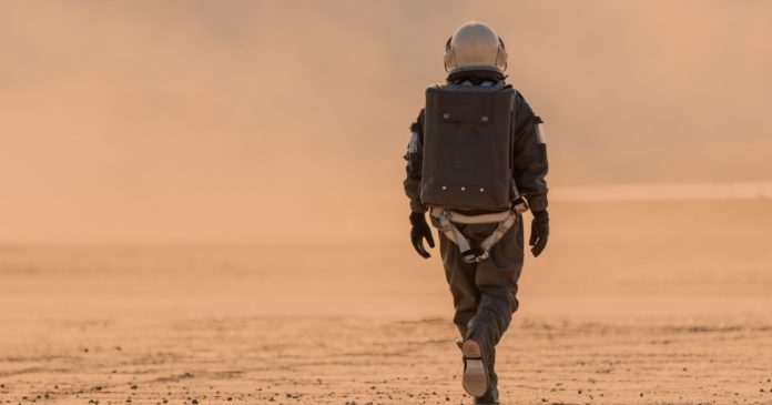 Fictional scene of an astronaut walking on another planet. 
