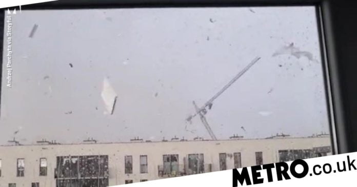 Poland: Terrifying moment gales topple 30m crane killing two workers