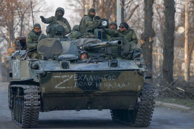 Ukrainian soldiers sit atop a captured Rsussian tank in Izyum as Putin prepares to send an additional 300,000 troops into the frontlines (Picture: Getty)