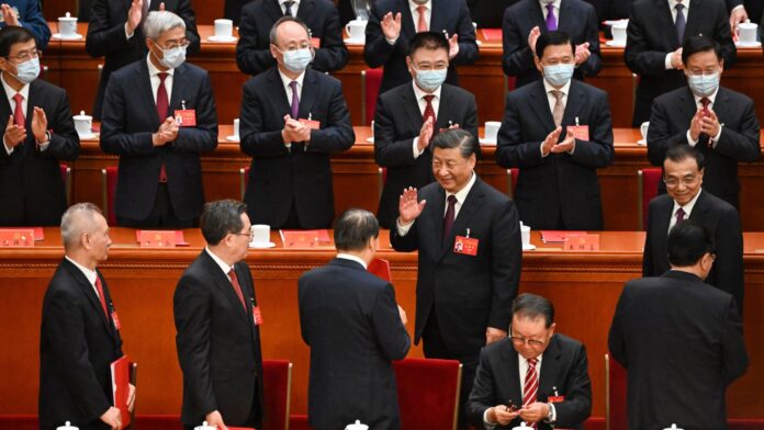China shuffles leadership committee and retains many Xi allies