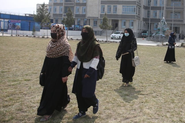 (220304) -- KABUL, March 4, 2022 (Xinhua) -- Afghan students are seen outside a building of Mustaqbal Pohanton University in Kabul, capital of Afghanistan, on March 2, 2022. At Mustaqbal Pohanton University on the eastern edge of Kabul, the new academic year has just begun. Universities in Afghanistan have been closed since August last year. (Photo by Saifurahman Safi/Xinhua) TO GO WITH Feature: Optimistic female Afghan students attend university classes