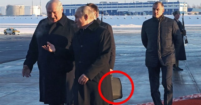 Putin flanked by aide with an armoured suitcase for Lukashekno meeting