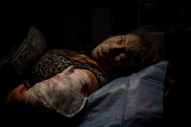 A resident wounded in a Russian attack lies in an ambulance before being taken to a hospital in Kherson, Ukraine, on Nov. 24, 2022. (AP Photo/Bernat Armangue)