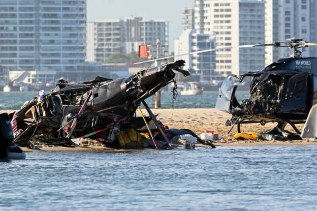 epa10386026 Two helicopters are seen following a collision near Seaworld, on the Gold Coast, Australia, 02 January 2023. Four people are dead and another 13 injured after two helicopters collided before one crashed into the Broadwater on the Gold Coast. EPA/DAVE HUNT AUSTRALIA AND NEW ZEALAND OUT