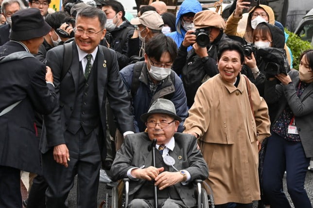 Hideko Hakamada (front-R) and supporters of her brother Iwao Hakamada (C) enter the Tokyo High Court on March 13, 2023. - Tokyo's High Court ordered a retrial for 87-year-old former boxer Hakamada, dubbed the world's longest-serving death row inmate, nearly six decades after he was convicted of murder. (Photo by Kazuhiro NOGI / AFP) (Photo by KAZUHIRO NOGI/AFP via Getty Images)