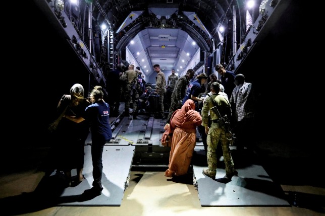 British nationals board an RAF aircraft during the evacuation to Cyprus, at Wadi Seidna airport, Sudan April 26, 2023. Arron Hoare/UK MOD/Handout via REUTERS THIS IMAGE HAS BEEN SUPPLIED BY A THIRD PARTY