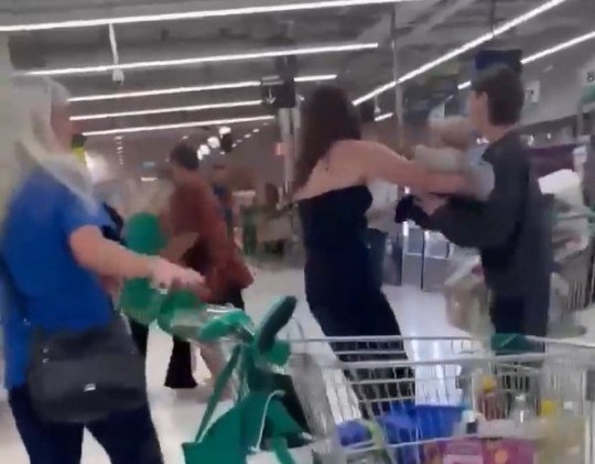 A screencapture of a video of people fighting in a supermarket.