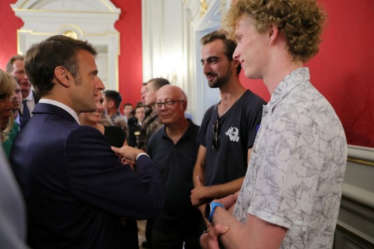 French President Emmanuel Macron and his wife Brigitte Macron meet Henri, the 24-year-old 'backpack hero', his friend Lilian and Youssouf, who suffered minor stab wounds as he tried to intercept the suspect as he fled, during a meeting with rescue forces at the Haute-Savoie prefecture, the day after several children and adults were injured in a knife attack at the Le Paquier park near the lake in Annecy, in the French Alps, France, June 9, 2023. REUTERS/Denis Balibouse/Pool